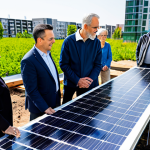 A diverse group of adults, men and women of various ages, fully clothed in appropriate, modest attire, are collaboratively engaging with a community-scale renewable energy project in an urban park. They are inspecting a section of a sleek solar panel installation, with a modern community building featuring rooftop gardens visible in the background. The atmosphere is positive and collaborative, reflecting local empowerment and sustainability. The lighting is bright and optimistic, showcasing a clean, professional environment. perfect anatomy, correct proportions, natural pose, well-formed hands, proper finger count, natural body proportions, professional photography, high-resolution, intricate details, natural lighting, safe for work, appropriate content, fully clothed, professional, family-friendly.